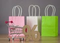 Shopping cart from the supermarket with sign percent on gray background. Shopping in the Mall, shop, shopping, a large selection Royalty Free Stock Photo