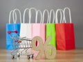 Shopping cart from the supermarket with sign percent on gray background. Shopping in the Mall, shop, shopping, a large selection Royalty Free Stock Photo