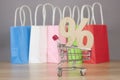 Shopping cart from the supermarket with sign percent on gray background. Shopping in the Mall, shop, shopping, a large selection Royalty Free Stock Photo