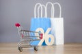 Shopping cart from the supermarket with sign percent on gray background. Shopping in the Mall, shop, shopping, a large selection Royalty Free Stock Photo