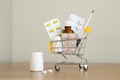 Shopping cart toy with medicaments: pills, blister packs, medical bottles, thermometer set. Health care and medicine concept