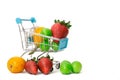 Shopping cart and various fruits. plum, loquat and strawberry on white background