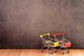 Shopping cart on wooden table with old gray concrete wall for background.. Royalty Free Stock Photo