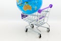 Shopping cart with world map for retail business. Image use for online and offline shopping, marketing place world wide, business Royalty Free Stock Photo