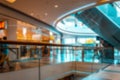 Shopping center blurred background. People shopping in modern commercial mall center. Interior of retail centre store in Royalty Free Stock Photo