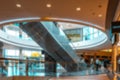 Shopping center building blurred background. People shopping in modern commercial mall center. Interior of retail centre Royalty Free Stock Photo