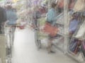 Shopping center, shop mall store. Woman in supermarket with shopping basket, retail. Abstract defocused motion blurred Royalty Free Stock Photo