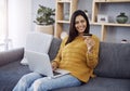 Shopping at the comfort of your own home. an attractive young woman doing some online shopping on her laptop while Royalty Free Stock Photo