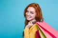 Shopping Concept - Close up Portrait young beautiful attractive redhair girl smiling looking at camera with shopping bag Royalty Free Stock Photo