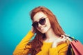 Shopping Concept - Close up Portrait young beautiful attractive redhair girl smiling looking at camera with shopping bag Royalty Free Stock Photo