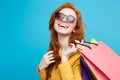 Shopping Concept - Close up Portrait young beautiful attractive redhair girl smiling looking at camera with shopping bag Royalty Free Stock Photo