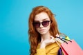 Shopping Concept - Close up Portrait young beautiful attractive redhair girl smiling looking at camera with shopping bag Royalty Free Stock Photo