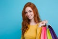 Shopping Concept - Close up Portrait young beautiful attractive redhair girl smiling looking at camera with shopping bag Royalty Free Stock Photo