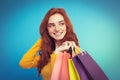 Shopping Concept - Close up Portrait young beautiful attractive redhair girl smiling looking at camera with shopping bag Royalty Free Stock Photo