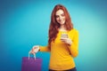 Shopping Concept - Close up Portrait young beautiful attractive redhair girl smiling looking at camera with shopping bag Royalty Free Stock Photo