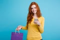 Shopping Concept - Close up Portrait young beautiful attractive redhair girl smiling looking at camera with shopping bag Royalty Free Stock Photo