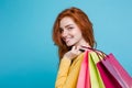 Shopping Concept - Close up Portrait young beautiful attractive redhair girl smiling looking at camera with shopping bag Royalty Free Stock Photo