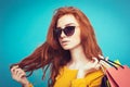 Shopping Concept - Close up Portrait young beautiful attractive redhair girl smiling looking at camera with shopping bag Royalty Free Stock Photo