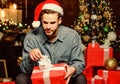 Shopping concept. How to Choose Perfect Gift. Man Santa claus with gift box. Handsome guy celebrate christmas. Perfect