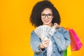 Shopping Concept - Portrait young beautiful african american woman smiling and joyful with colorful shopping bags and money