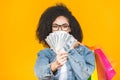 Shopping Concept - Portrait young beautiful african american woman smiling and joyful with colorful shopping bags and money