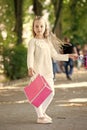 Pretty little girl walking with the pink shopping bags Royalty Free Stock Photo