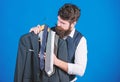 Shopping concept. Shop assistant or personal stylist service. Stylist advice. Matching necktie with outfit. Man bearded