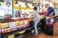 Shopping couple selects cherries with vendor at Pike Place Market, Seattle