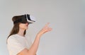 Shopping in cyberspace. Young woman in virtual reality headset chooses gifts on the Internet Royalty Free Stock Photo