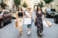 Three female friends walk after shopping Royalty Free Stock Photo