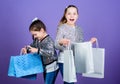 Shopping day. Children bunch packages. Kids fashion. Girls sisters friends with shopping bags violet background. Because Royalty Free Stock Photo