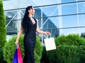 Shopping day. Woman holding colored bags near her shooping mall in black friday holiday Royalty Free Stock Photo