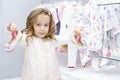 Shopping. discounts. little girl shopaholic. girl chooses shoes for her dress. shopping center, Royalty Free Stock Photo