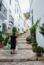 Elderly lady carrying shopping home in the white village (pueblo blanco) Frigiliana, Spain - September 2014