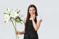 Shopping, employees and small business concept. Smiling attractive saleswoman in flower shop wearing apron, looking