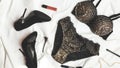 Shopping and fashion concept. Set of glamorous stylish sexy lace lingerie with cosmetic products, woman accessories on whie bed Royalty Free Stock Photo