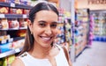 Shopping, groceries and consumerism with a young woman in a grocery store, retail shop or supermarket aisle. Closeup Royalty Free Stock Photo