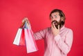 Shopping happiness. happy bearded man with present pack. cheerful brutal hipster hold gift. paper shopping bag. birthday Royalty Free Stock Photo