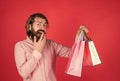 Shopping happiness. happy bearded man with present pack. cheerful brutal hipster hold gift. paper shopping bag. birthday Royalty Free Stock Photo