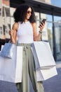 Shopping, happy customer and woman with phone smile about shopping mall discount and sale. Black woman, shopping bag Royalty Free Stock Photo