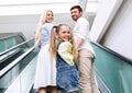 Family Smiling At Camera Standing On Escalator In Mall Center Royalty Free Stock Photo