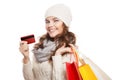 Shopping happy woman holding bags and credit card. Winter sales. Royalty Free Stock Photo