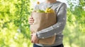 Close up of woman with paper bag full of food