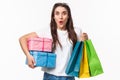 Shopping, holidays and lifestyle concept. Portrait of excited, amused young girl hurry up and buying presents, last days