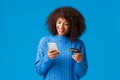 Shopping, holidays and presents concept. Attractive smiling african-american woman paying for online purchase, buying