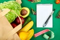 Shopping list, recipe book, diet plan. Grocering concept. Full paper bag of different fruits and vegetables, ingredients for Royalty Free Stock Photo