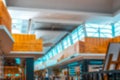 Shopping mall building blurred background. People shopping in modern commercial mall center. Interior of retail centre Royalty Free Stock Photo