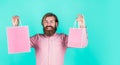 shopping in mall. cheerful brutal hipster hold gift. paper shopping bag. birthday surprise at party. man with package Royalty Free Stock Photo