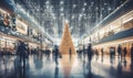 A shopping mall decorated for christmas with a large illuminated Christmas tree and busy shoppers Royalty Free Stock Photo