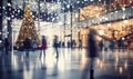 A shopping mall decorated for christmas with a large illuminated Christmas tree and busy shoppers